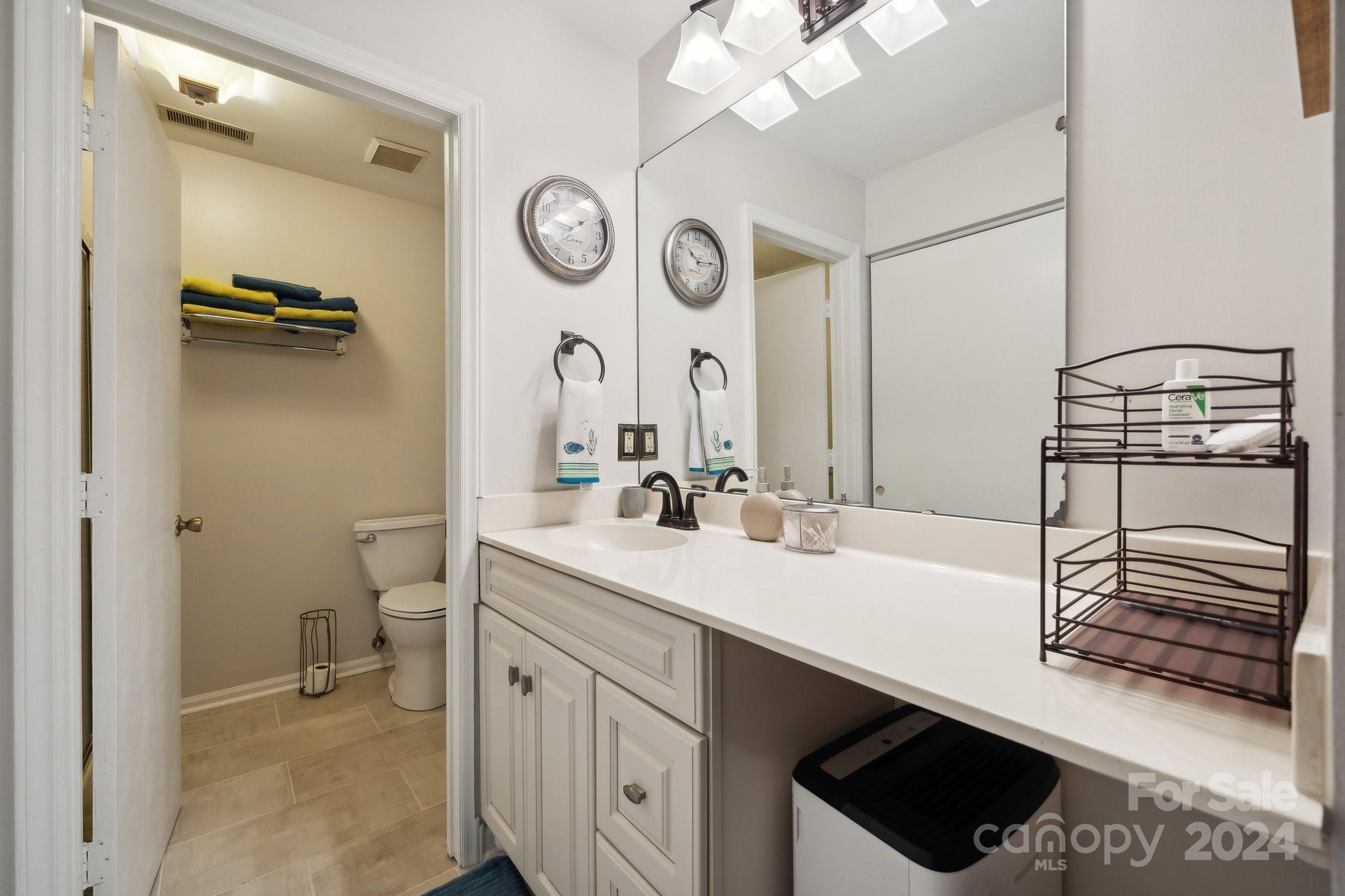 9012 St Thomas Lane Charlotte, NC 28277 - Photo 19 of 25 a bathroom with a sink a toilet and a mirror