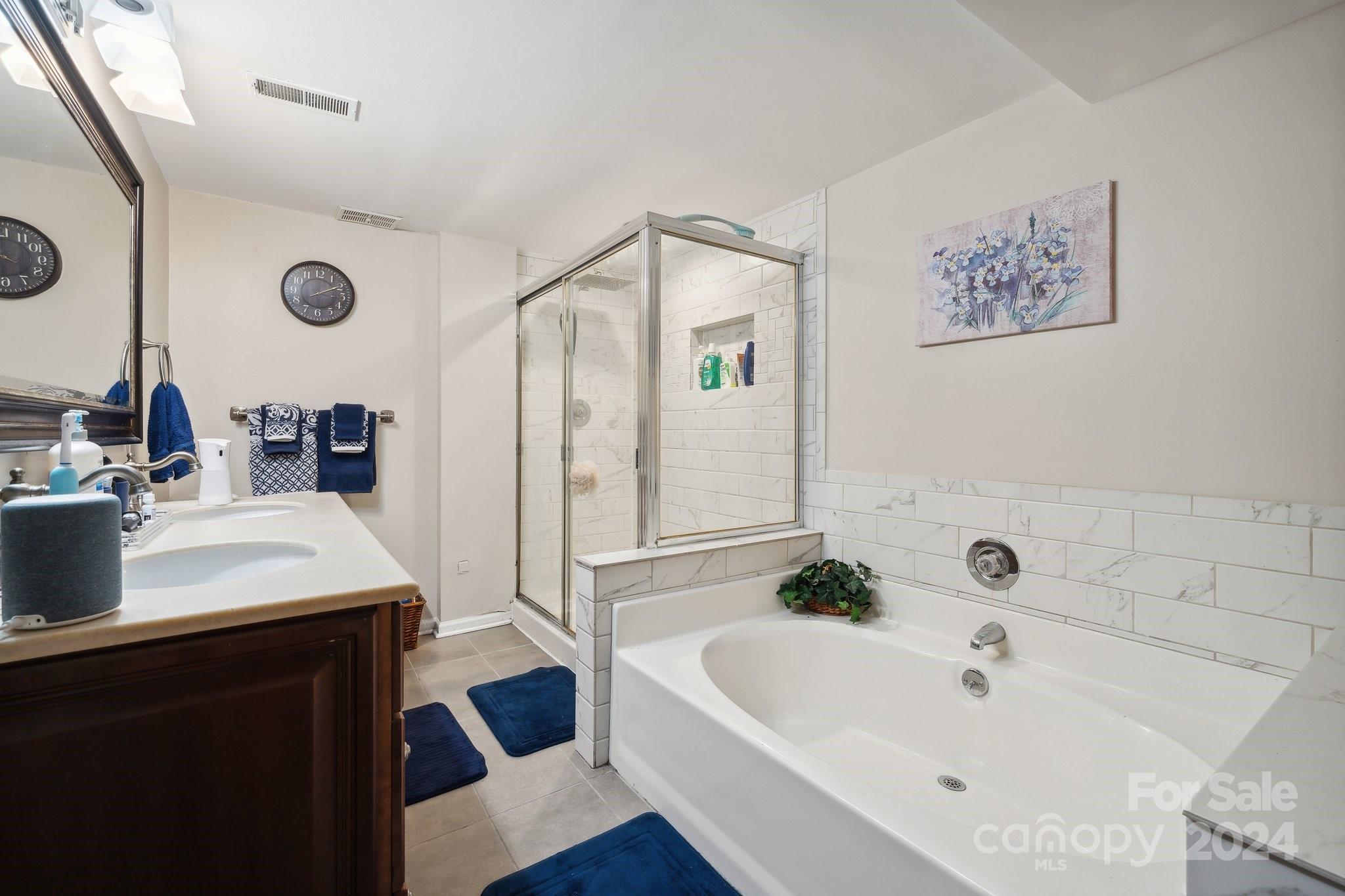 9012 St Thomas Lane Charlotte, NC 28277 - Photo 22 of 25 a bathroom with a tub a sink and a mirror
