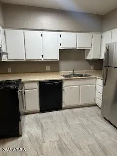 a kitchen with a sink and a refrigerator