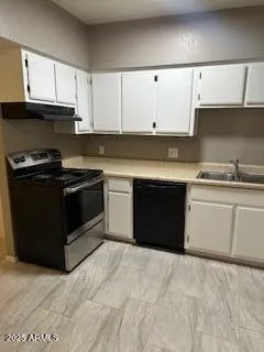 a kitchen with cabinets appliances and a sink
