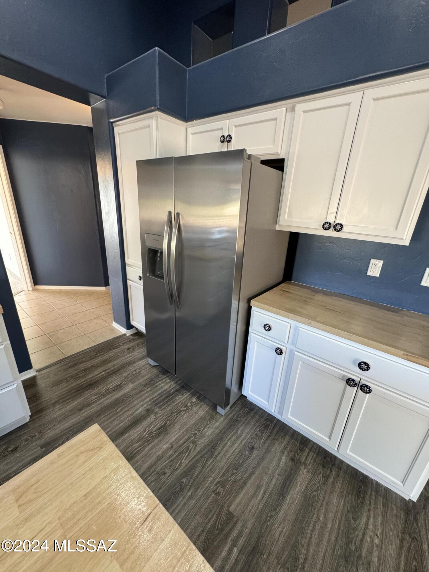 1841 America Court Rio Rico, AZ 85648 - Photo 18 of 38 a kitchen with white cabinets and stainless steel appliances