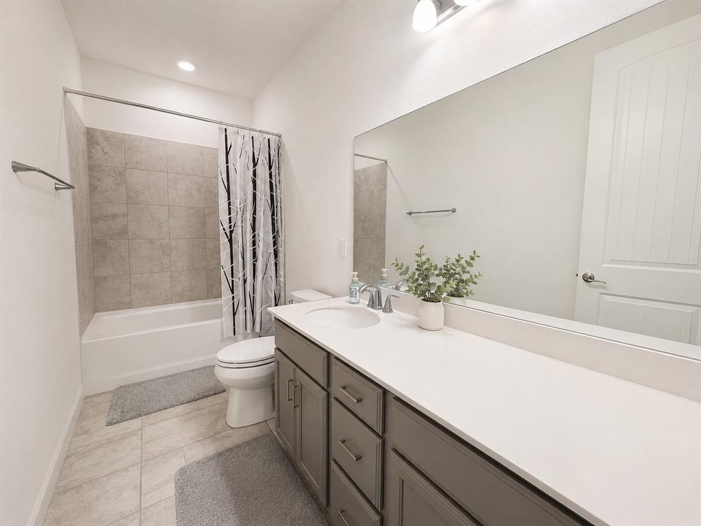 3598 Furrow Road Frisco, TX 75035 - Photo 11 of 14 a bathroom with a sink a toilet and bathtub