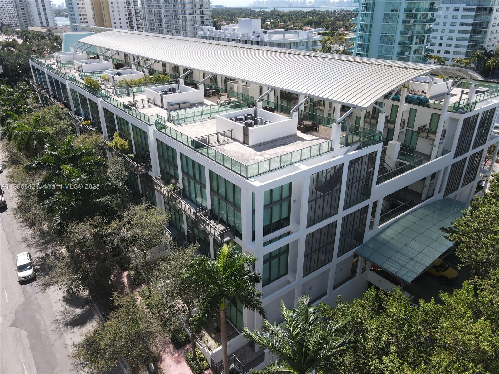 6000 Collins Avenue, Unit 528 Miami Beach, FL 33140 - Photo 25 of 26 a terrace with outdoor seating and trees