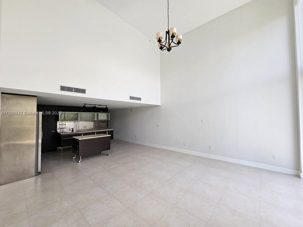 6000 Collins Avenue, Unit 528 Miami Beach, FL 33140 - Photo 4 of 26 a living room with furniture and a chandelier