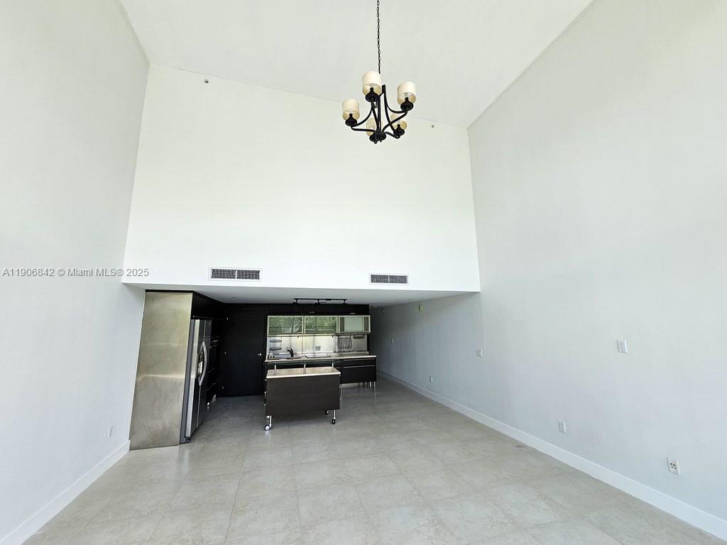 6000 Collins Avenue, Unit 528 Miami Beach, FL 33140 - Photo 5 of 26 a view of a room with a hanging light and garage
