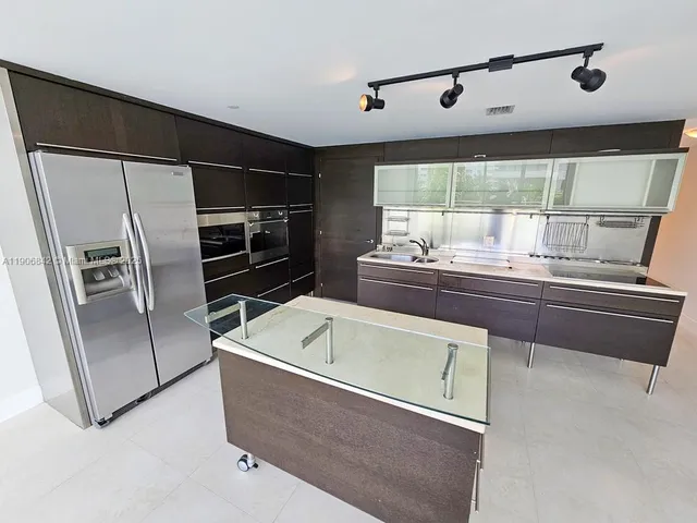 a kitchen with a refrigerator and a sink