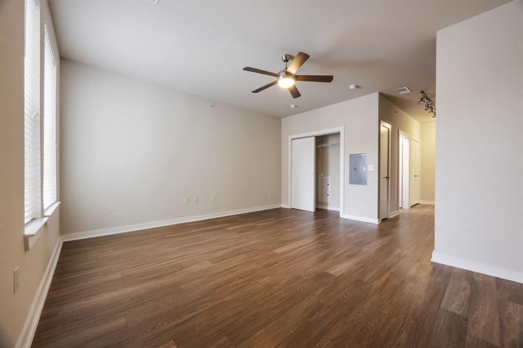 1900 Barton Springs Road, Unit 3013 Austin, TX 78704 - Photo 13 of 27 Well-lit living area features rich wood flooring and a convenient ceiling fan.