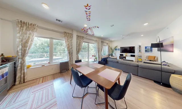 a large kitchen with cabinets wooden floor and stainless steel appliances