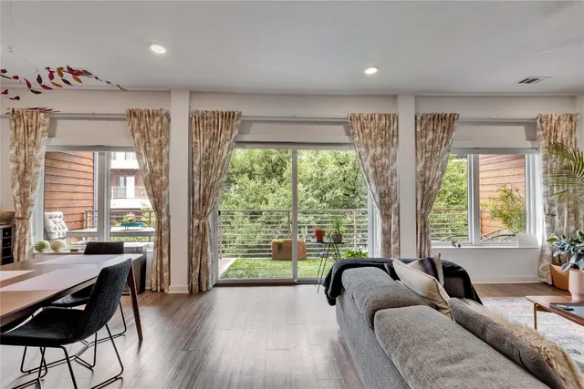 a living room filled with furniture and a large window
