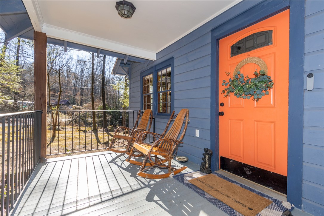 205 Rocky Bottom Road Sunset, SC 29685 - Photo 4 of 46 A welcoming covered porch with wood flooring overlooks the peaceful surrounding trees.
