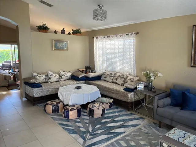 a living room with furniture and a large window