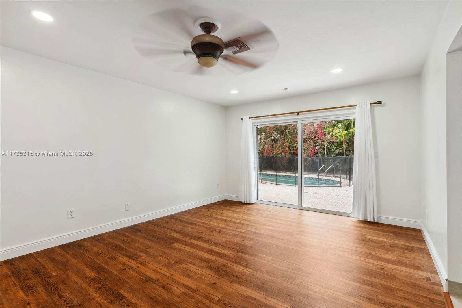 11601 Island Road Cooper City, FL 33026 - Photo 18 of 35 a view of empty room with wooden floor and fan