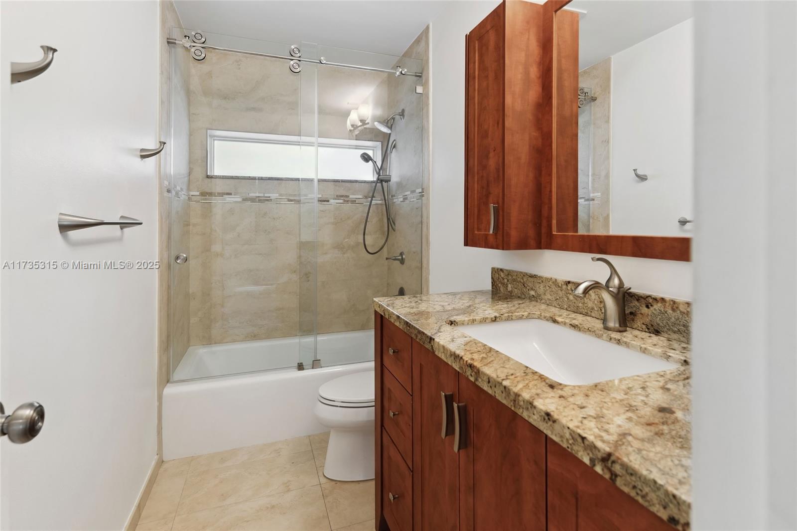 11601 Island Road Cooper City, FL 33026 - Photo 24 of 35 a bathroom with a granite countertop sink toilet and shower