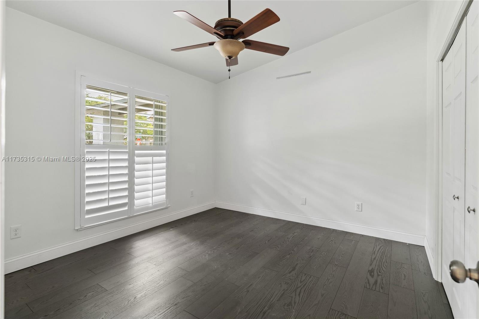 11601 Island Road Cooper City, FL 33026 - Photo 25 of 35 an empty room with wooden floor fan and windows