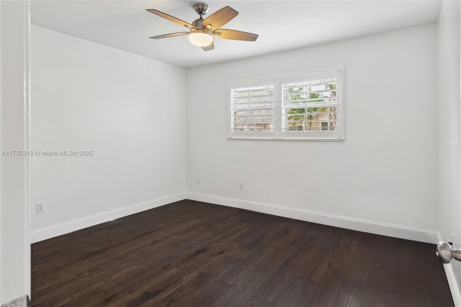 11601 Island Road Cooper City, FL 33026 - Photo 27 of 35 an empty room with wooden floor fan and windows