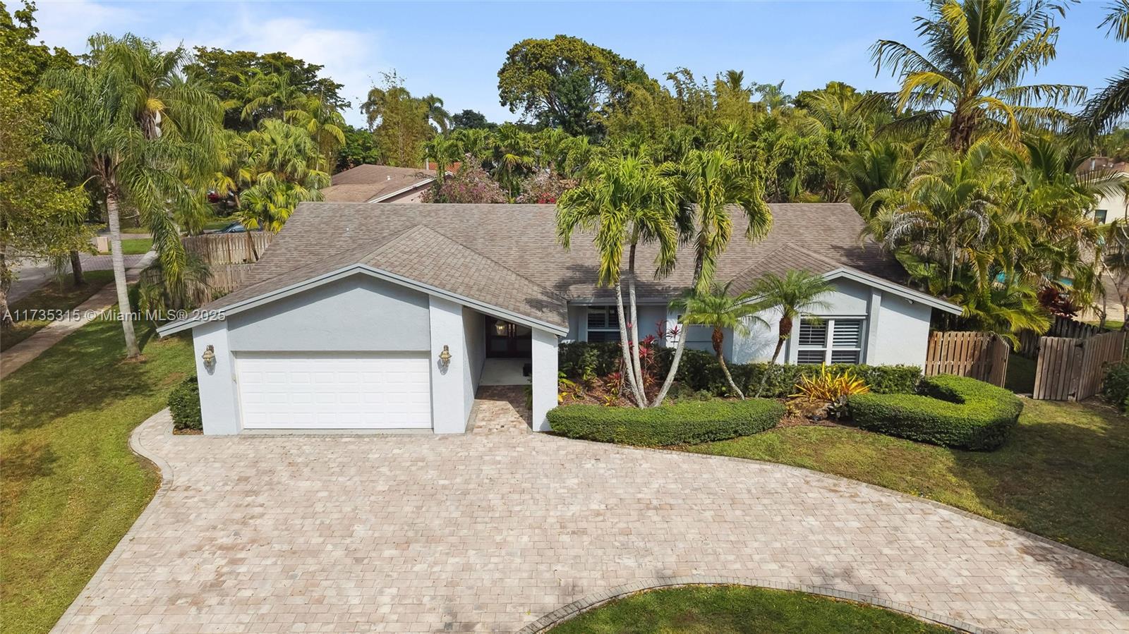 11601 Island Road Cooper City, FL 33026 - Photo 4 of 35 a front view of a house with a yard and garage