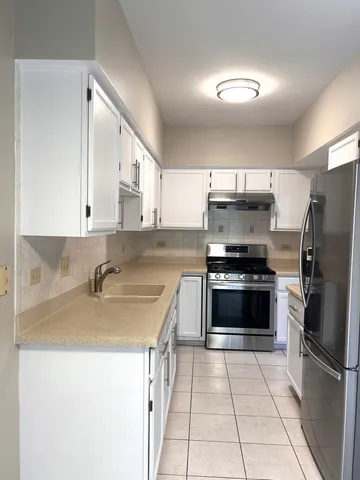 a kitchen with a sink a stove and refrigerator