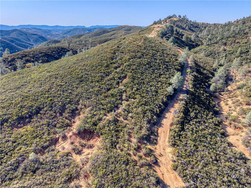 1034 Round Ball Road Clearlake Oaks, CA 95423 - Photo 16 of 46 a view of a large building with mountains in the background