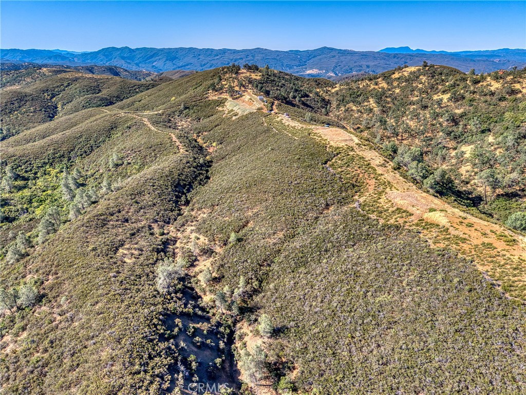 1034 Round Ball Road Clearlake Oaks, CA 95423 - Photo 38 of 46 a view of a mountain range with a lush green hillside
