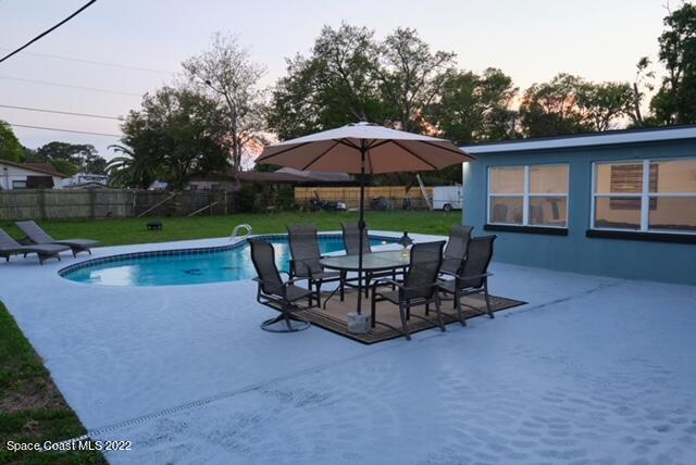 2855 Diamond Road Titusville, FL 32796 - Photo 12 of 61 a view of a roof deck with table and chairs under an umbrella