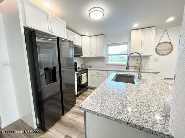 2855 Diamond Road Titusville, FL 32796 - Photo 19 of 61 a kitchen with stainless steel appliances granite countertop a sink a refrigerator and a stove