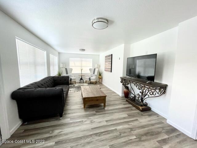2855 Diamond Road Titusville, FL 32796 - Photo 29 of 61 a living room with furniture and a flat screen tv