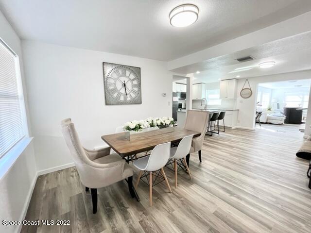 2855 Diamond Road Titusville, FL 32796 - Photo 33 of 61 a view of a dining room with furniture and wooden floor