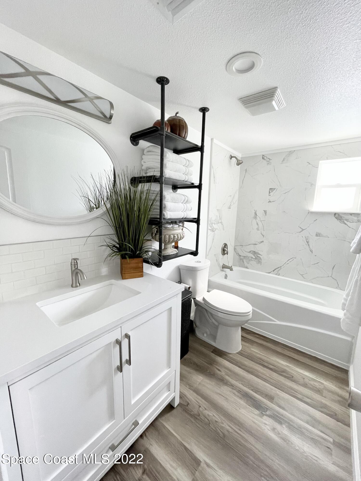 2855 Diamond Road Titusville, FL 32796 - Photo 37 of 61 a bathroom with a sink a toilet and a bathtub