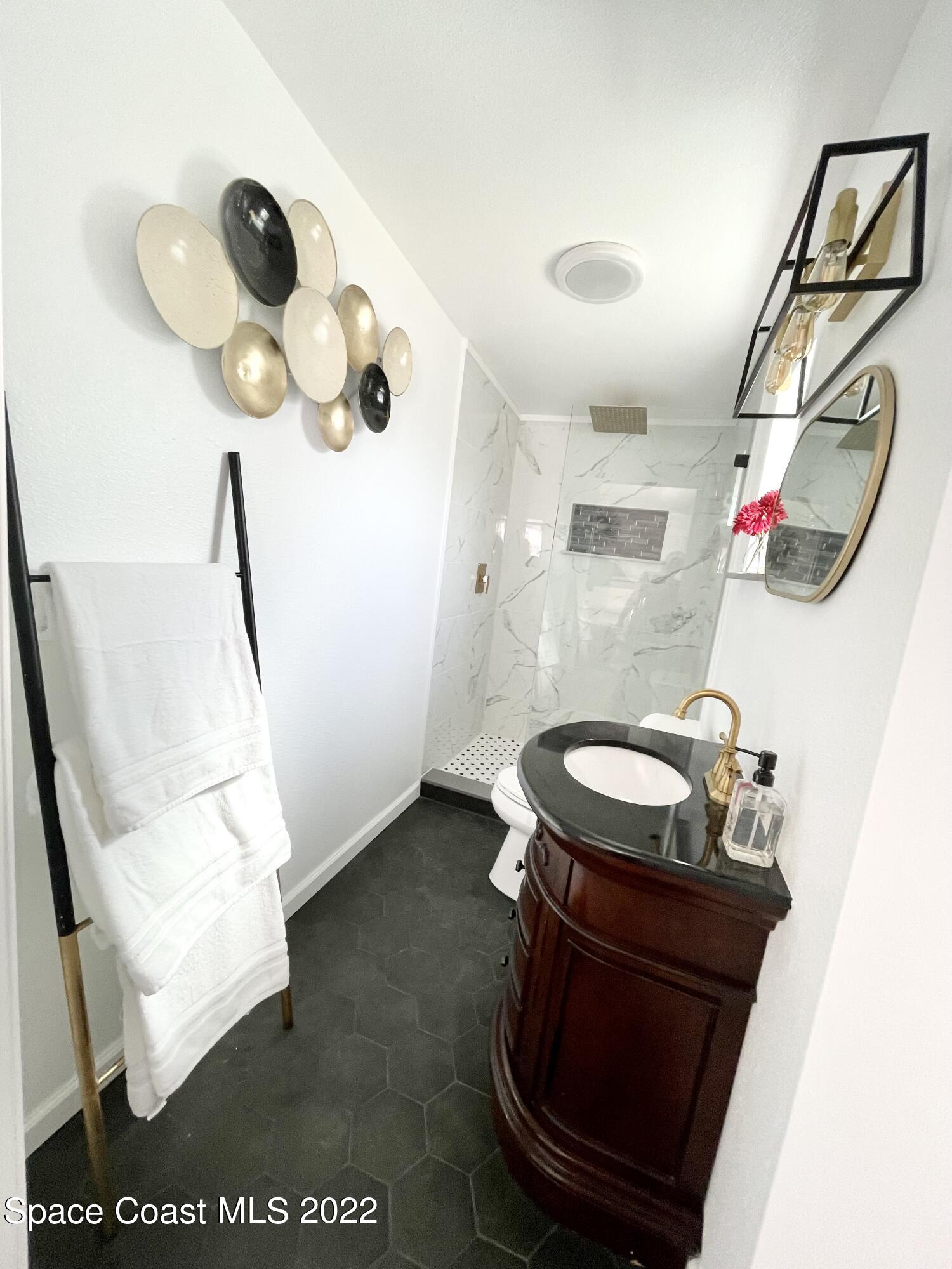 2855 Diamond Road Titusville, FL 32796 - Photo 42 of 61 a bathroom with a sink mirror and vanity