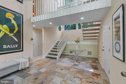 a view of a backyard with furniture and garden
