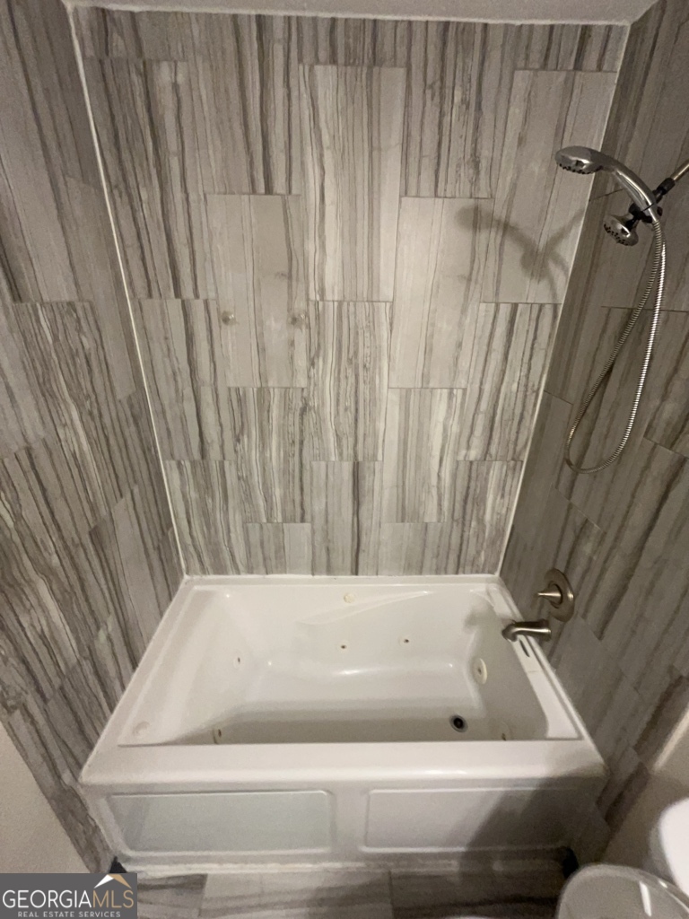 1265 Herrington Road Lawrenceville, GA 30044 - Photo 27 of 52 a bathroom with a bathtub