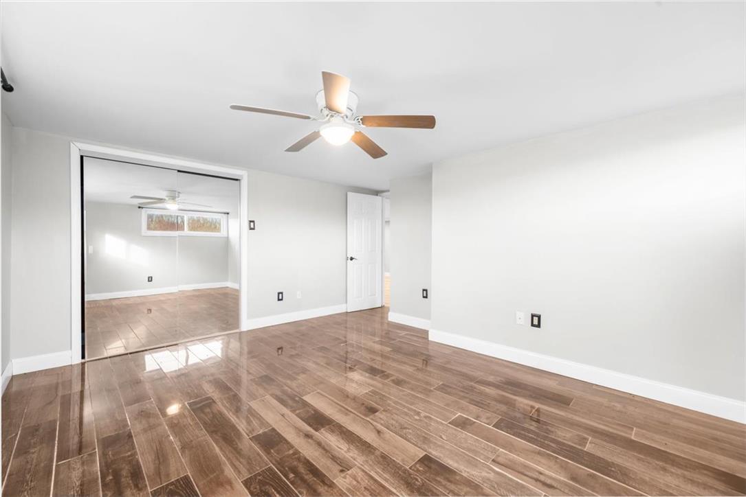 988 Hoch Road Danielsville, PA 18038 - Photo 16 of 29 Reflective wood flooring enhances this spacious bedroom with a modern ceiling fan for comfort.