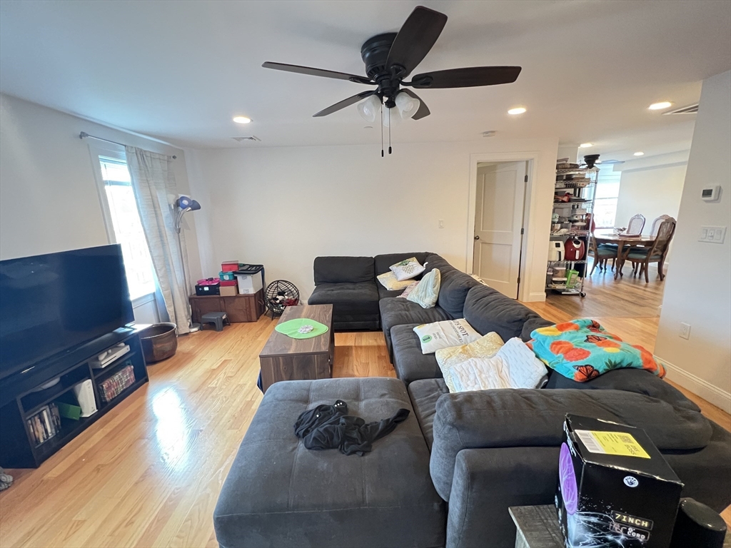 489 Main Street, Unit E Stoneham, MA 02180 - Photo 4 of 14 a living room with furniture and a flat screen tv
