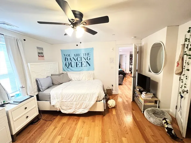 a spacious bedroom with a bed and a mirror