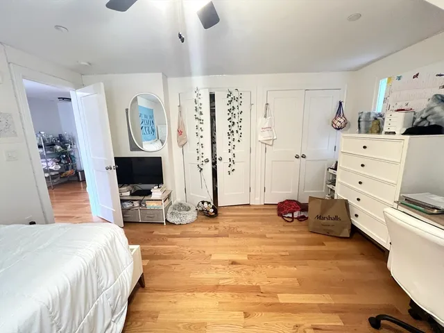 a bedroom with a bed and a flat tv screen