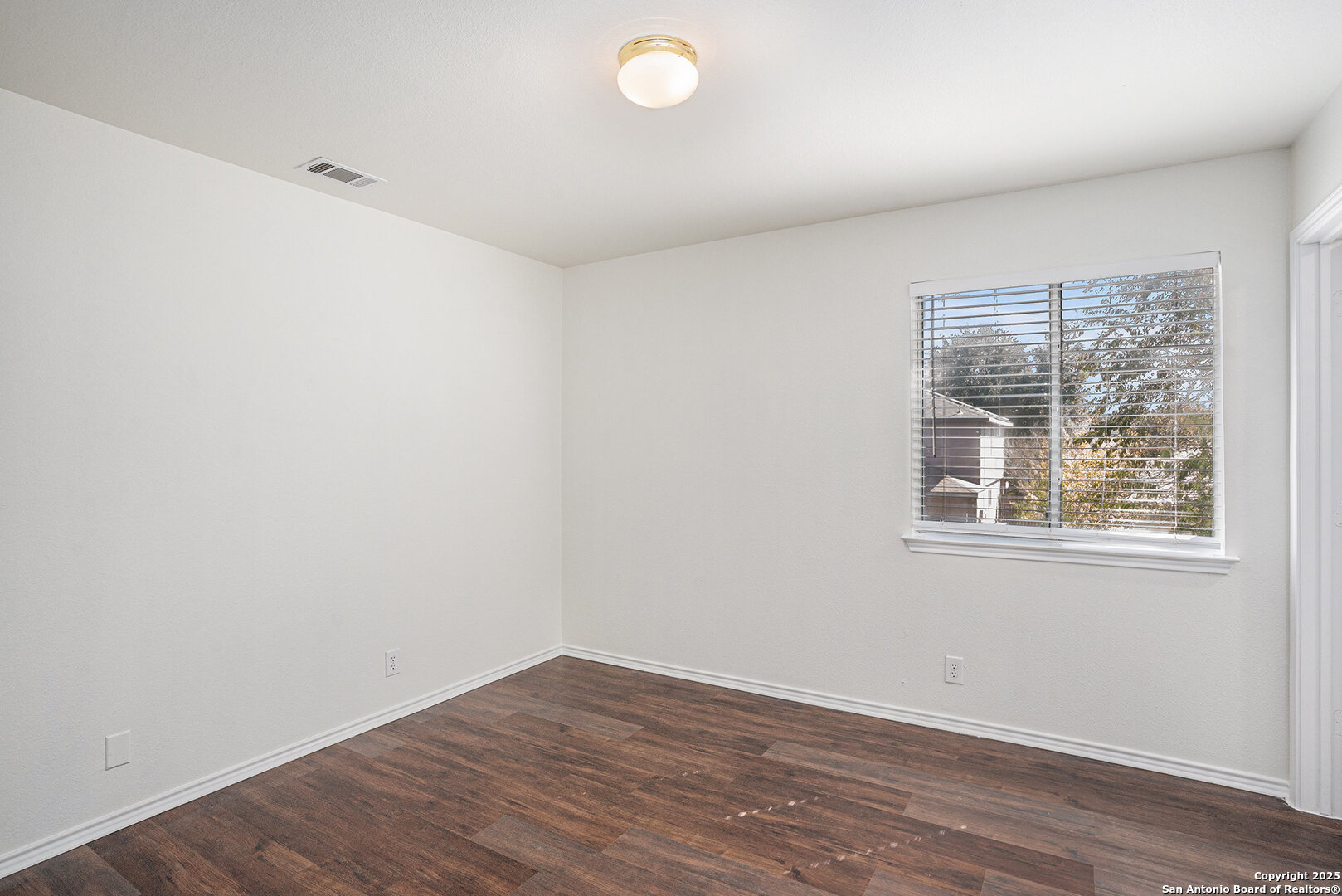 9106 Valhalla Selma, TX 78154 - Photo 12 of 17 an empty room with wooden floor and windows