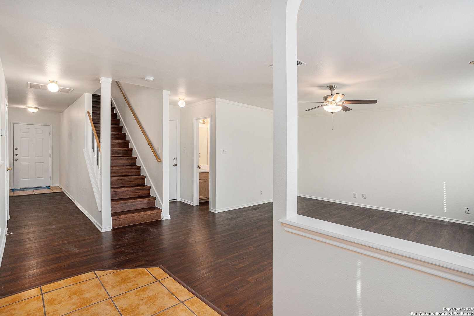 9106 Valhalla Selma, TX 78154 - Photo 2 of 17 an entryway in a hall with wooden floor and stairs