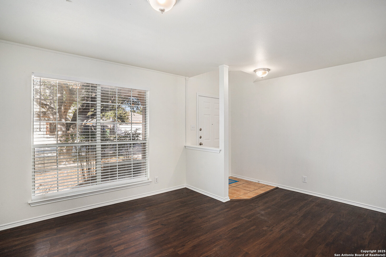 9106 Valhalla Selma, TX 78154 - Photo 3 of 17 a view of an empty room with wooden floor and a window