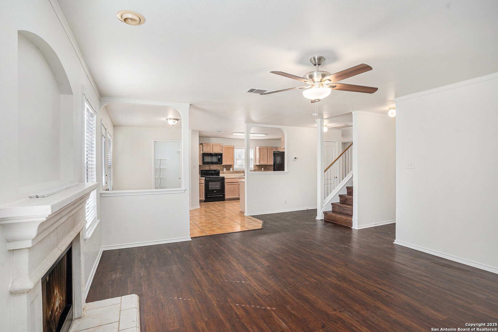 9106 Valhalla Selma, TX 78154 - Photo 5 of 17 a view of a kitchen with wooden floor and a ceiling fan