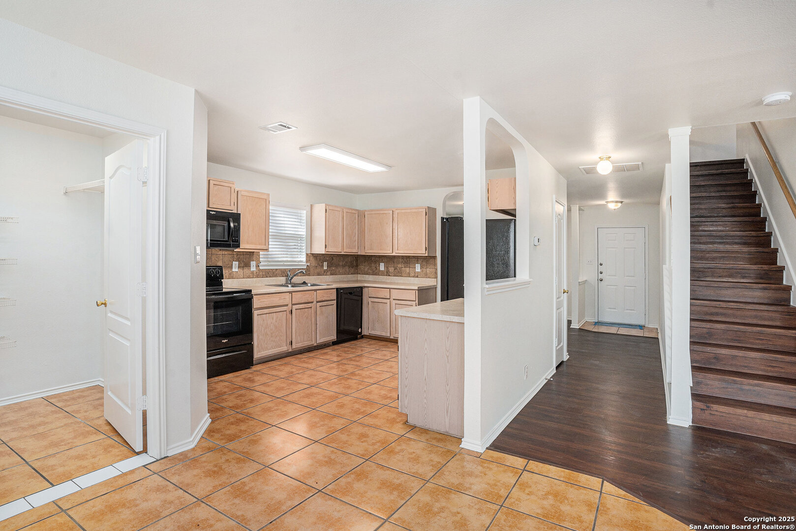 9106 Valhalla Selma, TX 78154 - Photo 6 of 17 a kitchen with cabinets and white appliances