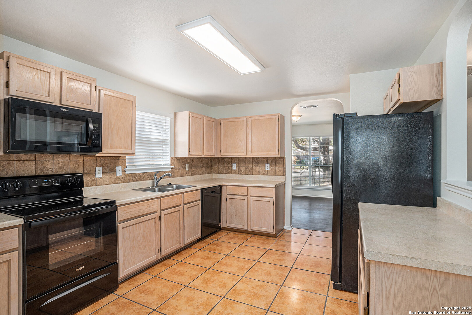 9106 Valhalla Selma, TX 78154 - Photo 7 of 17 a kitchen with a sink a stove top oven and refrigerator