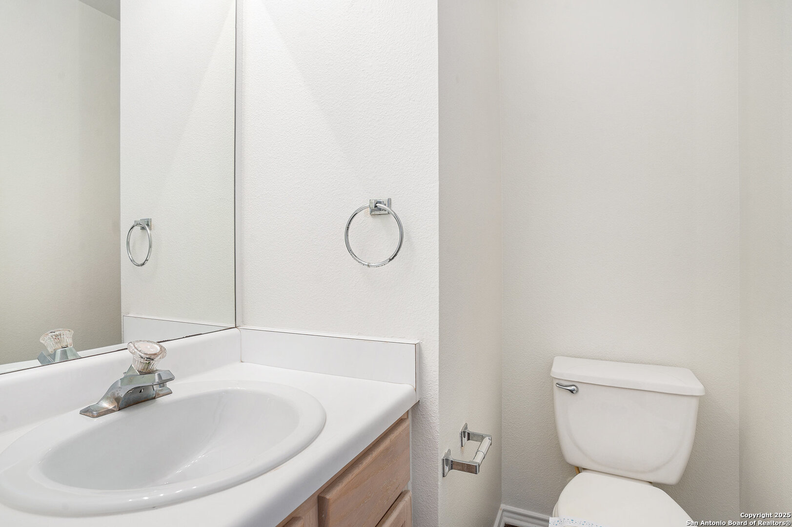 9106 Valhalla Selma, TX 78154 - Photo 9 of 17 a bathroom with a toilet sink and mirror