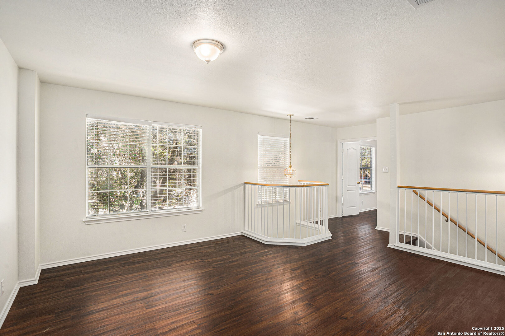 9106 Valhalla Selma, TX 78154 - Photo 10 of 17 a view of an empty room with wooden floor and a window