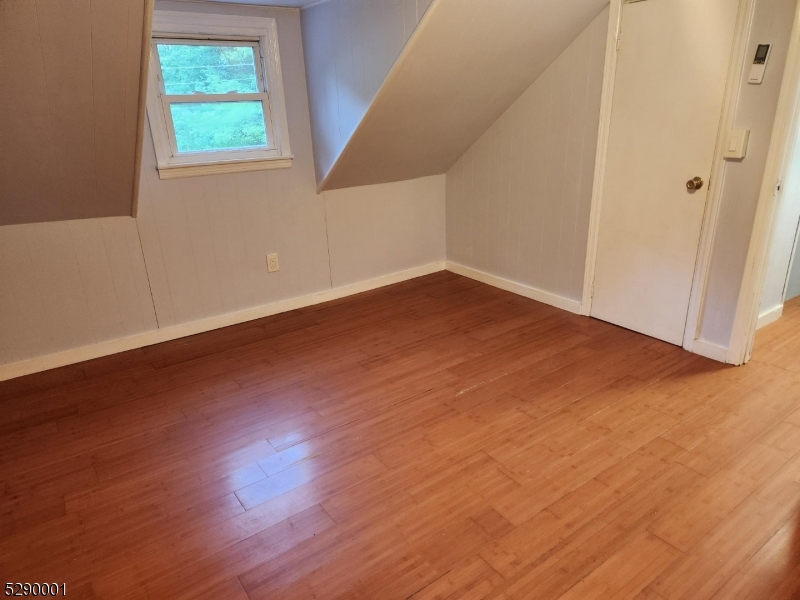 72 Glenwood Mt Road Vernon, NJ 07461 - Photo 6 of 12 an empty room with wooden floor and windows