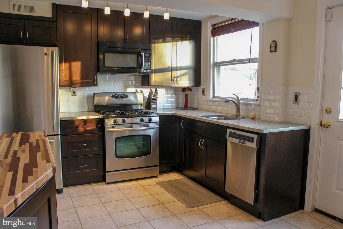 3616 South Kemper Road Arlington, VA 22206 - Photo 2 of 24 a kitchen with stainless steel appliances granite countertop a sink stove and refrigerator