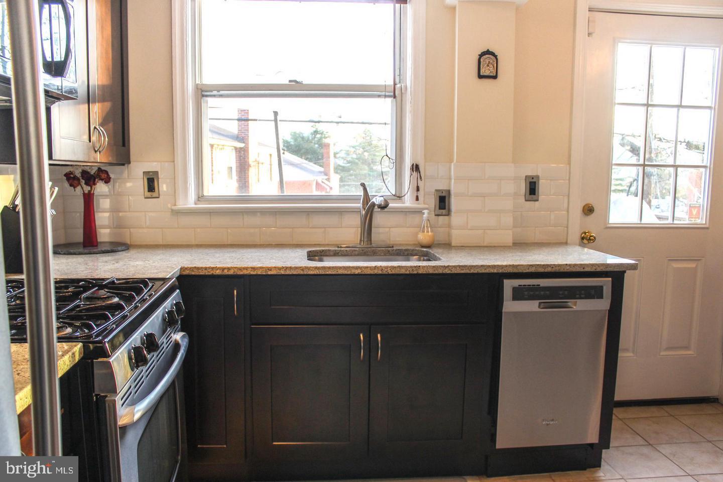 3616 South Kemper Road Arlington, VA 22206 - Photo 3 of 24 a kitchen with a sink stove and cabinets
