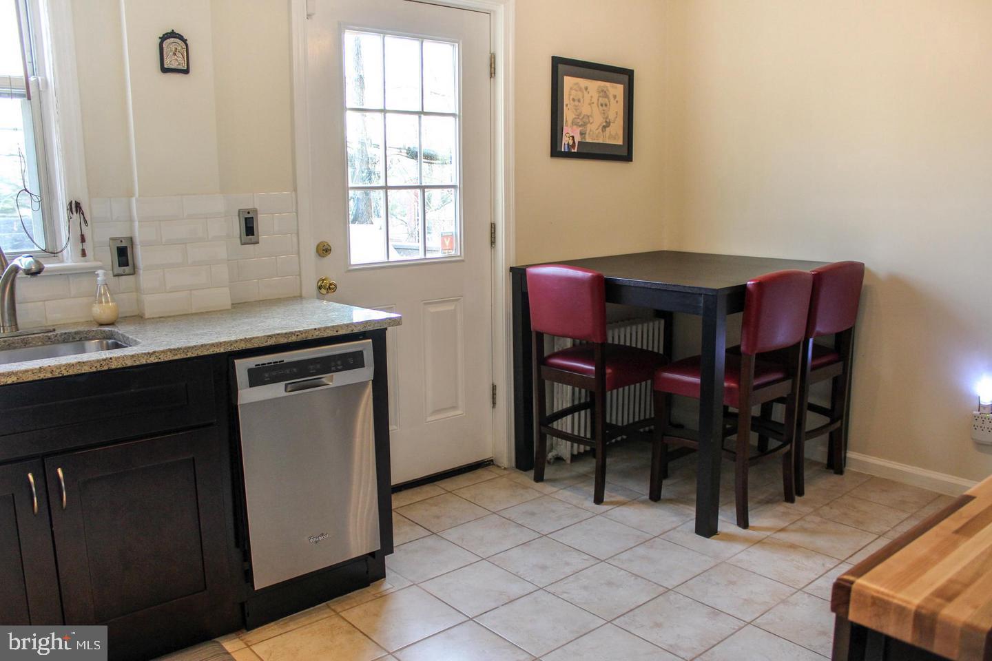 3616 South Kemper Road Arlington, VA 22206 - Photo 4 of 24 a dining room with a table chairs and a window