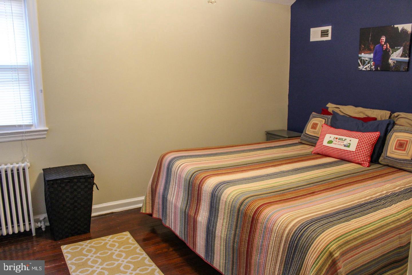 3616 South Kemper Road Arlington, VA 22206 - Photo 7 of 24 a bedroom with a bed and wooden floor