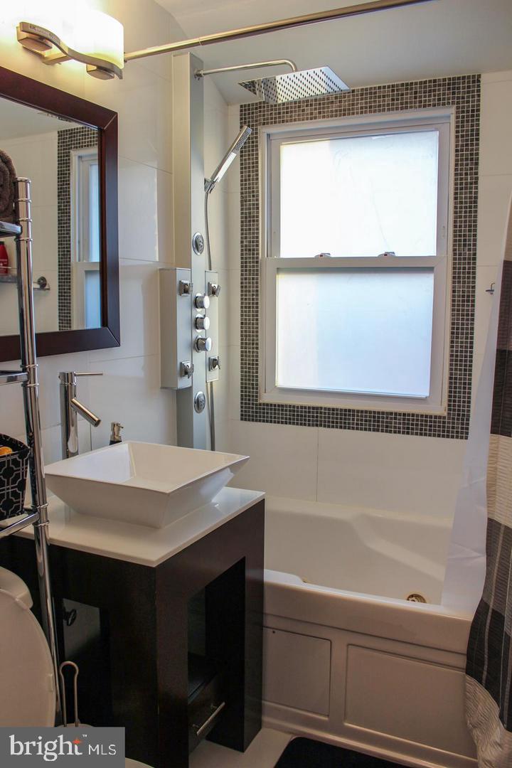 3616 South Kemper Road Arlington, VA 22206 - Photo 9 of 24 a bathroom with a sink vanity and a mirror