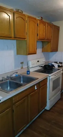 a kitchen with stainless steel appliances granite countertop a sink a stove and cabinets